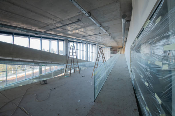 istock A captivating view of a modern business building under construction, showcasing its raw industrial interior with exposed steel beams and concrete walls bathed in the warm, golden hues of a sunset 2192391781