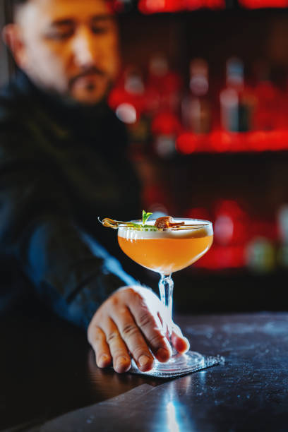 istock Close-up of a bartender serving a refreshing drink at the bar 2192397329