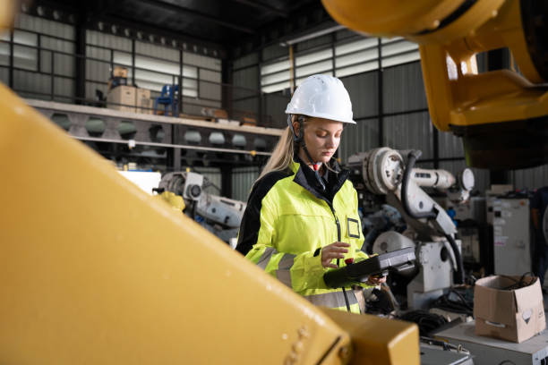 istock Business or engineer Caucasian woman checking with control a robot arm with remote computer 2192401992