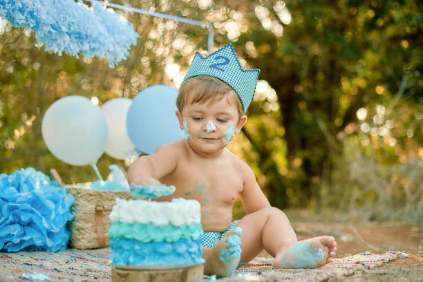 istock Toddler celebrating second birthday with a cake smash outdoors 2192402059