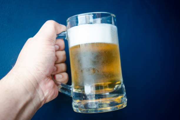 istock The person holding a beer cup with foam on top 2192403008