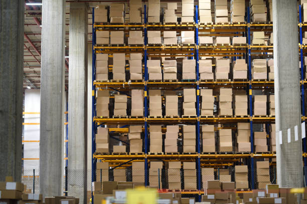 istock Stacked Cardboard Boxes on Industrial Shelves 2192404819