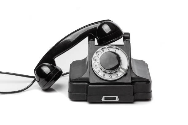 Vintage black telephone  on a white bachground. Telecom technology conept