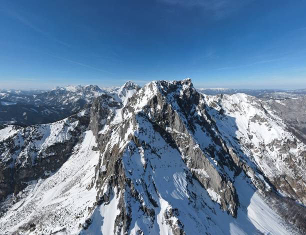 istock Majestic Mountain Range with Dramatic Rock Formations and Lush Green Valleys 2192407003