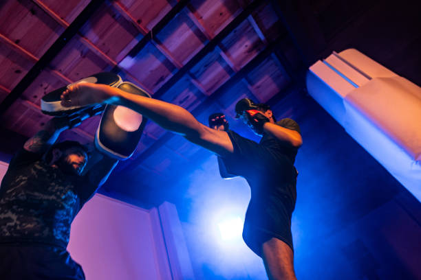 istock Fighter doing kicks with the help of trainer at the gym 2192407074