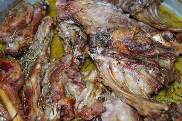 Roasted lamb, homemade recipe. Lamb is seasoned with aromatic herbs and spices, garnished with sprigs of fresh rosemary. Juicy meat is tender and succulent