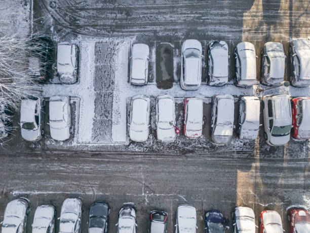 istock Removing snow from car on parking lot 2192408193