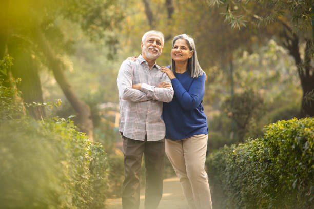 istock Happy senior couple holding hands in park 2192408986
