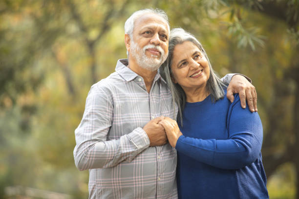 istock Happy senior couple holding hands in park 2192409144