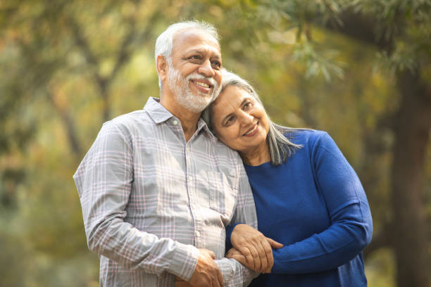 istock Happy senior couple holding hands in park 2192409171