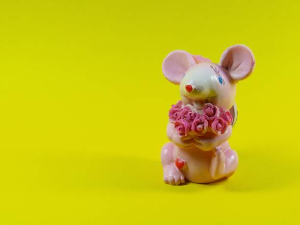 Pink mouse with a bouquet of flowers. Congratulations on your birthday and wedding. Invitation.