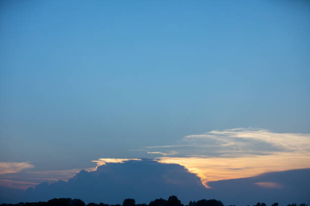 A beautifully tranquil evening sky, showcasing soft clouds along with vibrant colors that appear at sunset