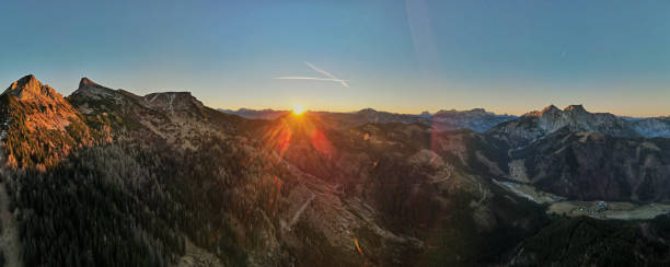 istock Sunlit Alpine Landscape with Lush Green Valleys and Rugged Peaks 2192410643
