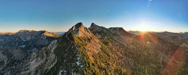 istock Sunlit Alpine Landscape with Lush Green Valleys and Rugged Peaks 2192410672
