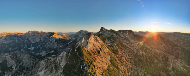 istock Sunlit Alpine Landscape with Lush Green Valleys and Rugged Peaks 2192410679