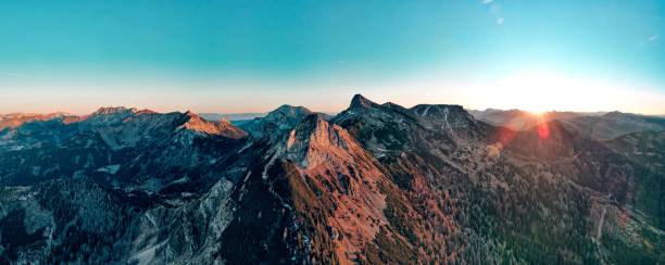 istock Sunlit Alpine Landscape with Lush Green Valleys and Rugged Peaks 2192410728