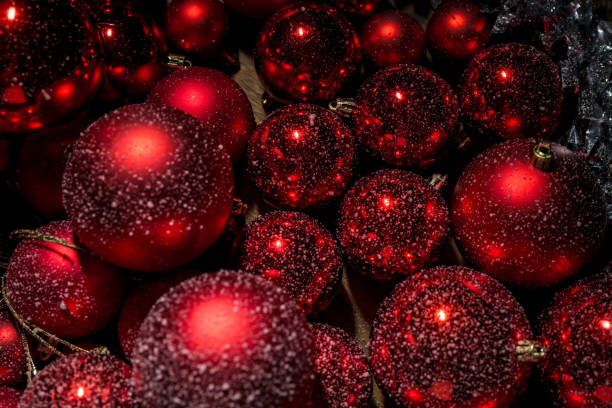 istock Red Christmas ornaments covered with snowflakes, animated snowfall 2192414675