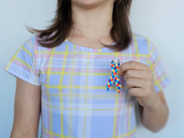 istock Child holding colorful ribbon symbolizing support for awareness causes indoors 2192414983
