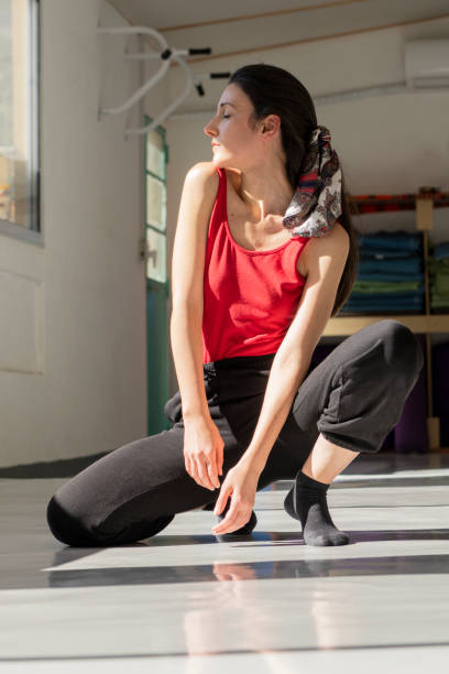 istock Young woman in relaxed pose at bright gym setting 2192415410