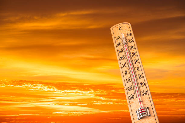 Hot temperature. Thermometer showing high temperature on yellow sky