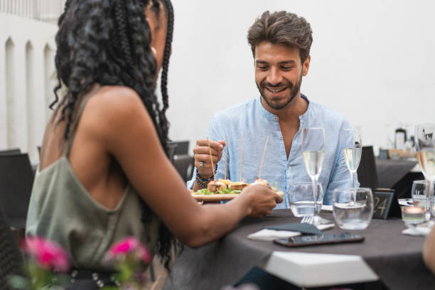 istock Man smiling while sharing food during an elegant outdoor dinner 2192417380
