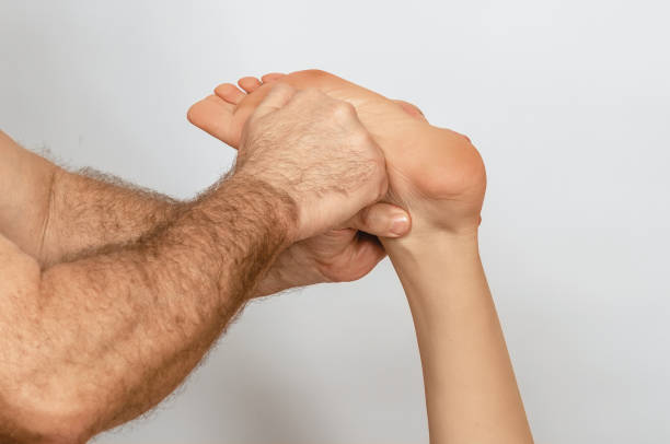 istock Foot massage performed with emphasis on therapist's hands, which press on base of the woman's foot. 2192418582