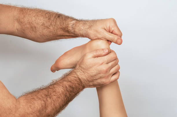 istock Foot massage is performed with emphasis on therapist's hands, which apply pressure to woman's heel. 2192418604