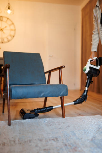 istock Person Vacuuming A Home Interior With A Modern Cordless Cleaner Device 2192418769