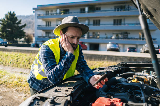 istock Man uses mobile phone near vehicle break down 2192423784