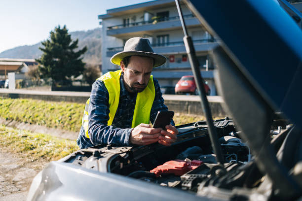 Man uses mobile phone near vehicle break down