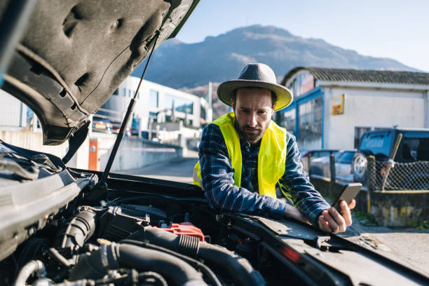 istock Man uses mobile phone near vehicle break down 2192423911