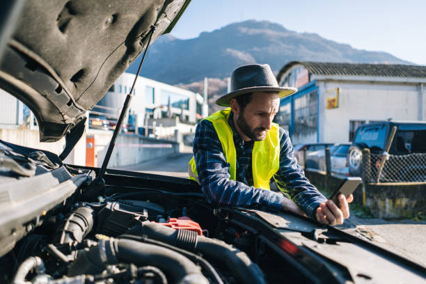istock Man uses mobile phone near vehicle break down 2192423999