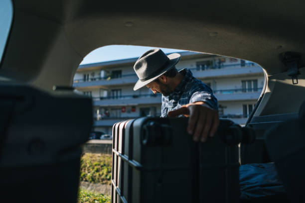 istock View from vehicle to man removing luggage 2192424051