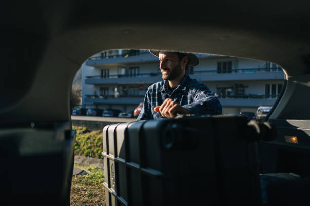 istock View from vehicle to man removing luggage 2192424113