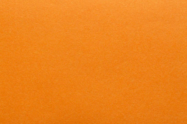 Orange paper sheet fabric texture. Orange canvas cardboard texture as a background. Orange paperboard photographic background