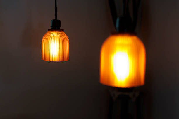 istock Warm orange pendant lights hangs elegantly in a cozy indoor space illuminated during the evening hours 2192427740