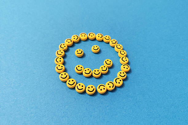 Smiley face made of beads on blue background