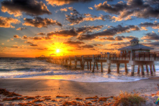 istock Juno Beach Pier Sunrise and Dark Clouds. 2192429286