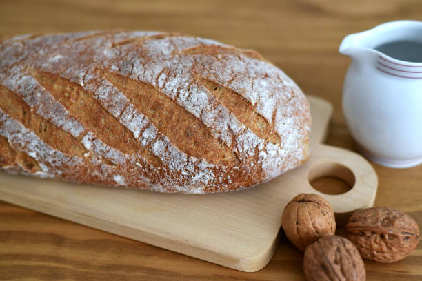 istock Loaf of bread on wooden cutting board 2192430914