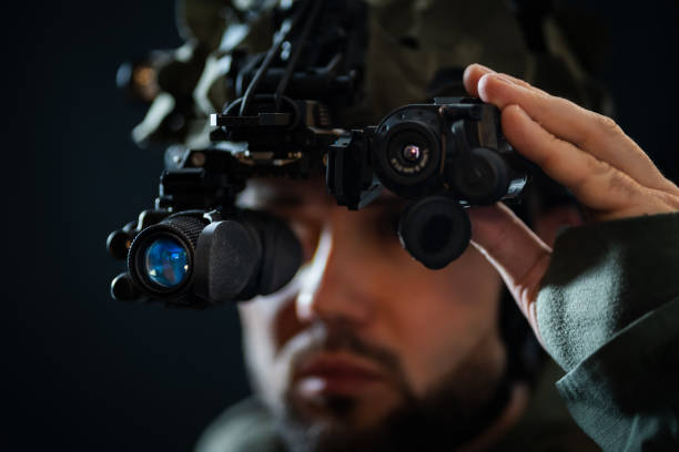 istock A military man using modern binocular night vision in the darkness. 2192432533
