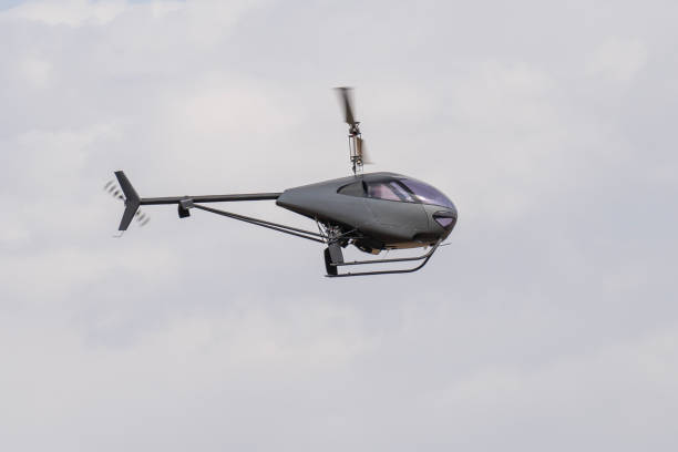 istock Modern gray two-seater small helicopter flying in the air 2192433050