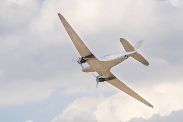 istock Vintage twin engine propeller plane flying in the cloudy sky 2192433077