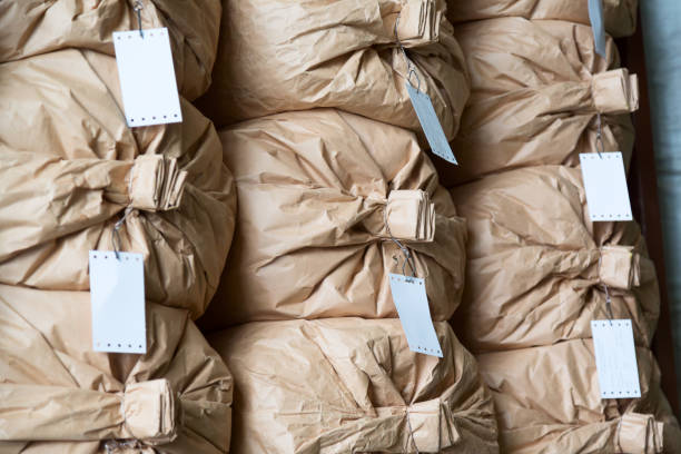 istock Factory warehouse concept. Stacked paper sacks in a warehouse. 2192434422