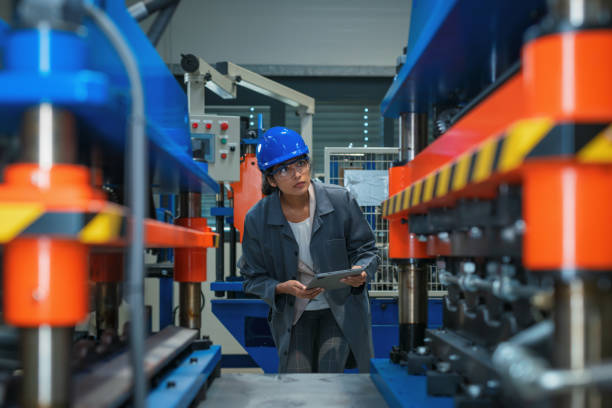 istock Indian woman engineer with a blue helmet doing factory machine inspection 2192434954