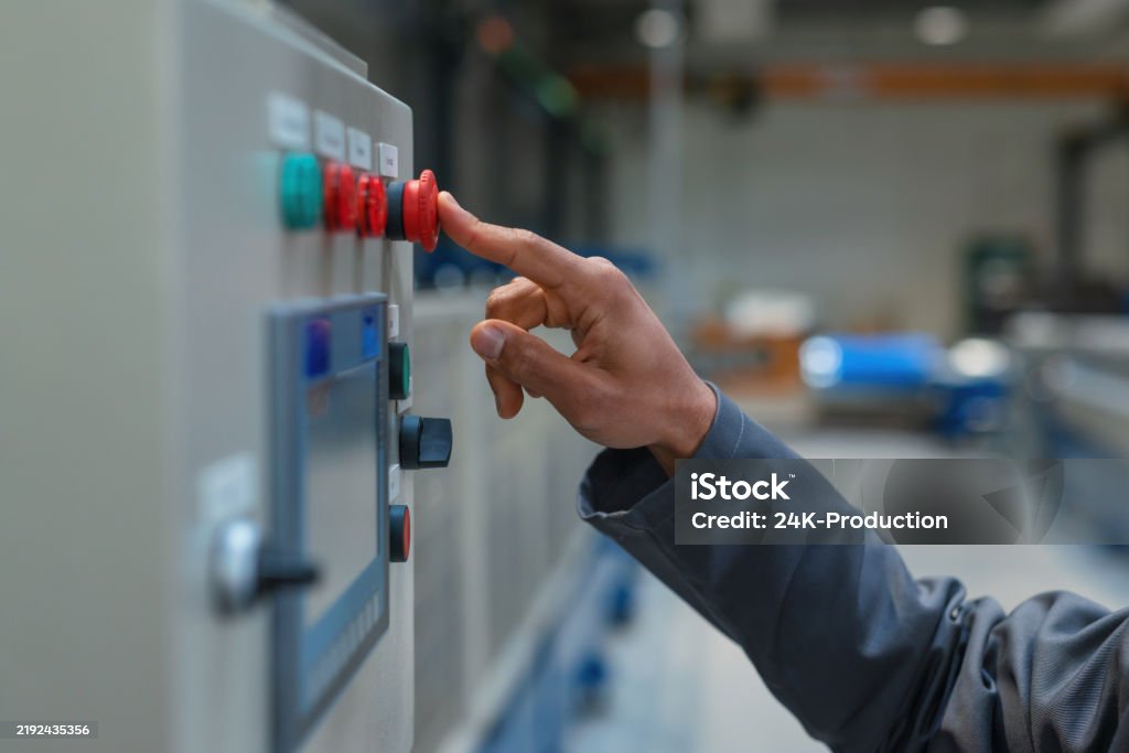 Safety Controls Engineer Engineer With Blue Helmet And Safety Goggles Operating A Control Panel ...