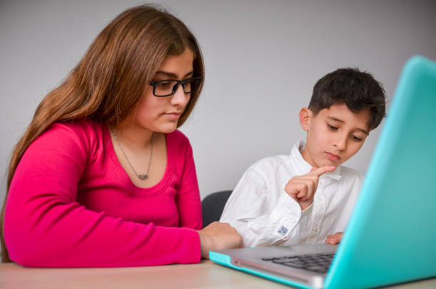Children Using Laptop Computer At Home