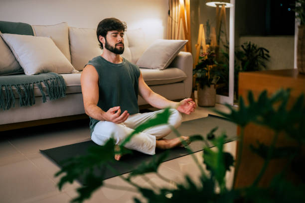 Hispanic Brazilian brunette bearded man peacefully practicing mindfulness in his living room