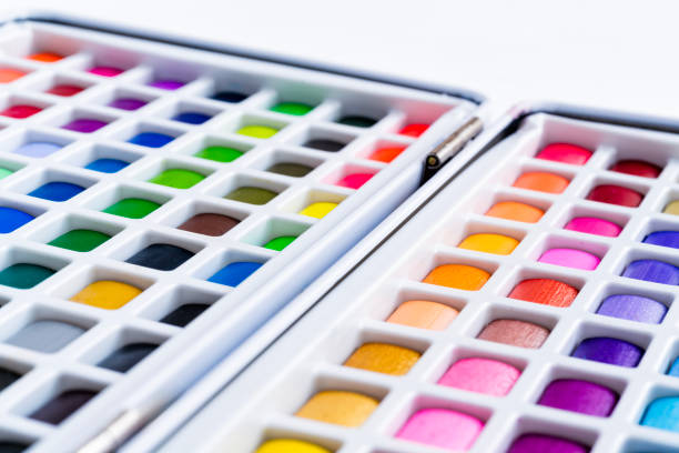 Watercolor Paint Swatches Detail - Colorful squares of paint in portable watercolor painting kit. Vivd colors and selective focus with soft blur bokeh.