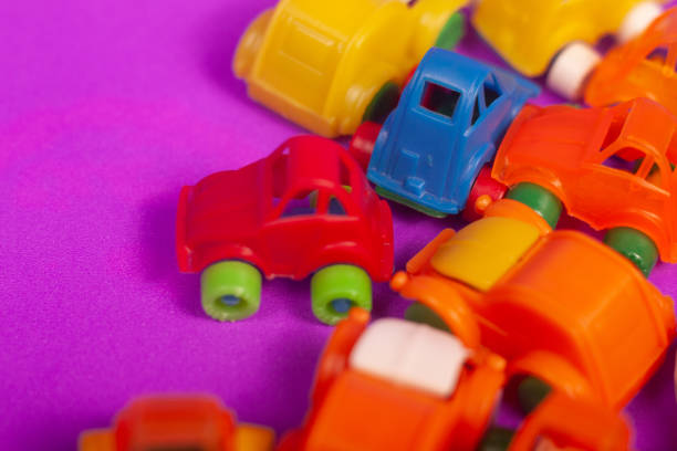plastic cars toys colorful on a purple background
