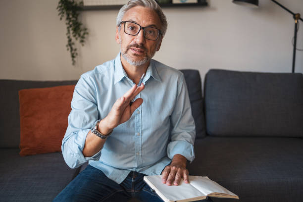 istock Mature man looking at the camera and talking. He is having a video call 2192440764
